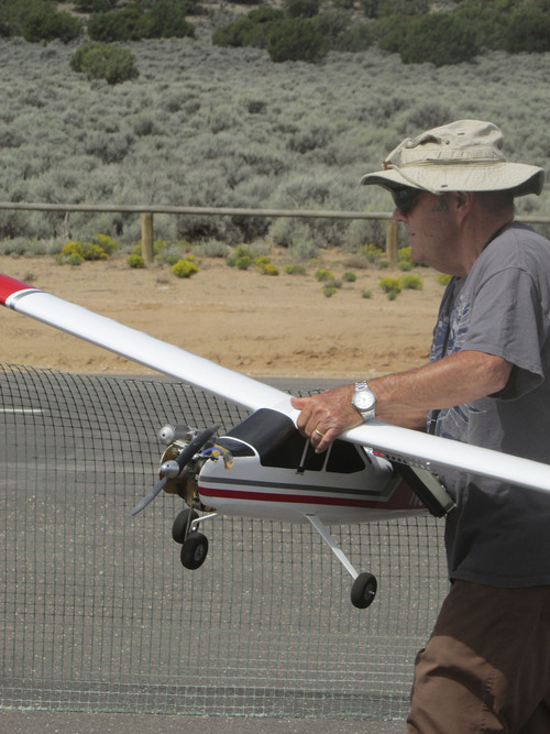 Tom Wharton  |  The Salt Lake Tribune
Arnold Vitarbo of Enoch controls a model airplane with radio panel.