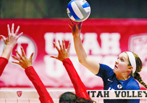 Steve Griffin | The Salt Lake Tribune

BYU's Tambre Haddock tips the ball over the Utah defense during volleyball match at the Huntsman Center in Salt Lake City, Utah Tuesday Sept. 17, 2013.