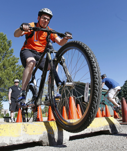 Al Hartmann  |  The Salt Lake Tribune
Salt Lake Police Officer Chad Smith bumps up and over a curb on an obstacle course for training to become a bike patrol officer.  Ten candidates from Salt Lake City police department and four officers from other agencies participated in the training at Sugar House Park Wednesday June 5.