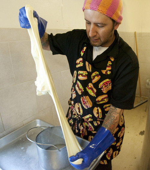 Steve Griffin | The Salt Lake Tribune

Cheese maker Fernando Chavez-Sandoval stretches the hand made mozzarella at Gold Creek Farm in Woodland, Utah, Monday Sept. 11, 2013.