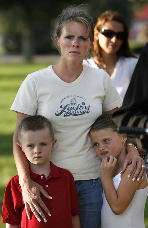 Huntington - Family members of miners missing in the Crandall Canyon coal mine stand with spokesman Sonny Olsen (not pictured) as he reads their statement to the media in the Huntington City Park. The family members wished to remain unidentified.
Trent Nelson/The Salt Lake Tribune; 8.23.2007