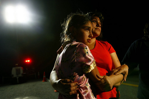 Huntington, UT--8/16/07--9:31:33 PM--
Maria Lerma, right, and her daughter Adilene embrace by the entrance to the mine in Crandall Canyon Thursday evening.  Maria's husband Natalio Lerma was uninjured in the latest bump.

******************************
A series of ambulances raced up and down Crandall Canyon tonight to the mine site where rescue workers have been trying to find six miners trapped since Aug. 6. At least two people working to find six trapped miners were injured Thursday night on the 11th day of the rescue effort, The Associated Press reported.
    There was a ''mountain bump" inside the mine, said the AP, according to a Price hospital official who said he couldn't be identified because he was not allowed to release information.
    A bump commonly refers to pressure inside the mine that shoots coal from the walls with great force.
    The first ambulance arrived around 7:10 p.m., made a quick turnaround. As it passed the Emery Canyon sheriff's command post at the foot of the mine road, two emergency medics appeared to be working on someone inside. The second ambulance followed about 15 minutes later. 

Chris Detrick/The Salt Lake Tribune
File #_2CD8504



`