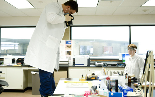 Kim Raff  |  The Salt Lake Tribune
Justin Masin, a forensic scientist, photographs evidence at the crime lab at the Utah Bureau of Forensic Services in West Valley City on February 11, 2013. The crime lab is slowly on the mend after years of losing staff to budget cuts and low wages.