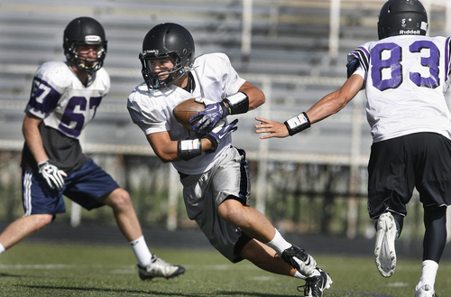 Scott Sommerdorf   |  The Salt Lake Tribune
Lehi running back Caden Calton takes a hand off during practice, Wednesday, September 18, 2013. Calton has run for almost 1,000 yards in just four games.