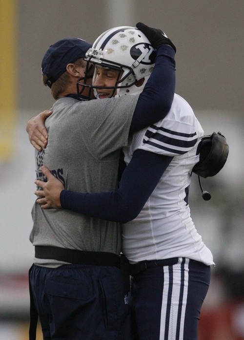 Trent Nelson  |  The Salt Lake Tribune
BYU coach Bronco Mendenhall embraces BYU kicker Mitch Payne (a senior) as BYU defeats UTEP in the New Mexico Bowl, college football Saturday, December 18, 2010 in Albuquerque, New Mexico.