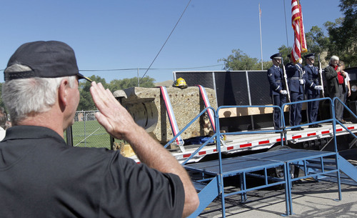 Al Hartmann  |  The Salt Lake Tribune
Jack Barns, left, President of the American Fallen Warriors Memorial Foundation salutes during a color guard ceremony where a 4 1/2 ton piece of the World Trade Center is displayed at  Fort Douglas Military Museum Friday September 20.    It will be on display Saturday at Rice-Eccles Stadium and then travel around the state. Eventually, the piece is to be put on permanent display in a planned peace park at Fort Douglas.
