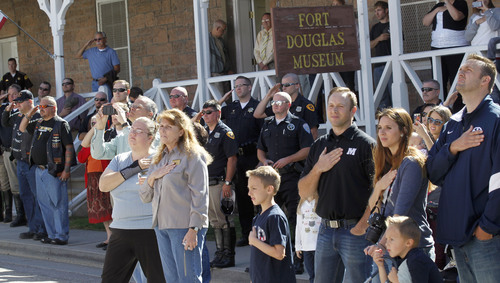 Al Hartmann  |  The Salt Lake Tribune
People salute at the Fort Douglas Military Museum during a color guard ceremony where a 4 1/2 ton piece of the World Trade Center went on display Friday September 20. It will be on display Saturday at Rice-Eccles Stadium and then travel around the state. Eventually, the piece is to be put on permanent display in a planned peace park at Fort Douglas.