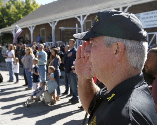 Al Hartmann  |  The Salt Lake Tribune
Jack Barns, right, president of the American Fallen Warriors Memorial Foundation, salutes with group gathered at the Fort Douglas Military Museum during color guard ceremony where a 4 1/2 ton piece of the World Trade Center went on display Friday September 20. It will be on display Saturday at Rice-Eccles Stadium and then travel around the state. Eventually, the piece is to be put on permanent display in a planned peace park at Fort Douglas.