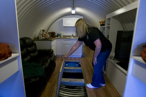 Rick Egan  | The Salt Lake Tribune 

Dawn Kaufman demonstrates the huge storage area in the Atlas survival shelter, Thursday, Sept. 19, 2013. The shelter at Emergency Essentials is open for public tours in Bountiful.