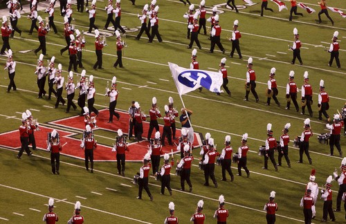 Trent Nelson  |  The Salt Lake Tribune
A flag carrier waves the BYU flag in the middle of the Utah Marching Band before the start of the game as Utah hosts BYU college football in Salt Lake City, Utah, Saturday, September 15, 2012.