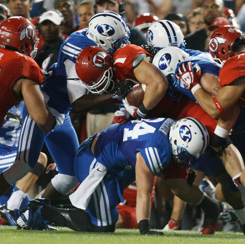Trent Nelson  |  The Salt Lake Tribune
Utah Utes tight end Jake Murphy (82) is brought down by BYU defenders in the first quarter as the BYU Cougars host the Utah Utes, college football Saturday, September 21, 2013 at LaVell Edwards Stadium in Provo.