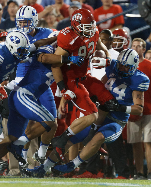 Trent Nelson  |  The Salt Lake Tribune
Utah Utes tight end Jake Murphy (82) is brought down by BYU defenders in the first quarter as the BYU Cougars host the Utah Utes, college football Saturday, September 21, 2013 at LaVell Edwards Stadium in Provo.