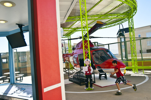 Chris Detrick  |  The Salt Lake Tribune
Ryan Netelbeek, 10, of Salt Lake City, runs to the helicopter at in the ìSaving Lives from the Skyî exhibit at the Discovery Gateway: The Childrenís Museum of Utah on Friday. The exhibit features an authentic Life Flight helicopter ó to include a mock Primary Childrenís Hospital Emergency Department. It includes interactive areas for dressing up and for performing triage, imaging and even surgery, using custom-designed iPad apps.