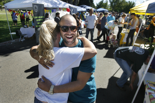 Scott Sommerdorf   |  The Salt Lake Tribune
Corey Howard of Mormons Building Bridges gives Michel Knowles a hug at her "Free Hugs" stand at Provo's first Pride Festival, held at Memorial Park in Provo on Saturday.