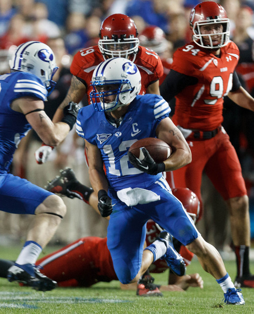 Trent Nelson  |  The Salt Lake Tribune
Brigham Young Cougars wide receiver JD Falslev (12) runs back a punt in the fourth quarter as the BYU Cougars host the Utah Utes, college football Saturday, September 21, 2013 at LaVell Edwards Stadium in Provo.