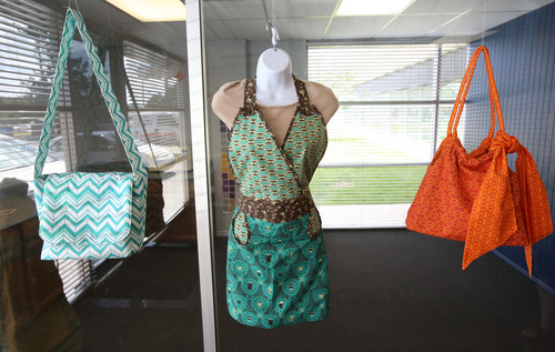Francisco Kjolseth  |  The Salt Lake Tribune
April Cobb, owner of Modern Yardage, a Utah-based fabric design and making company, puts together some of the designs they carry and print on cotton as examples in the showroom of the small Woods Cross business.