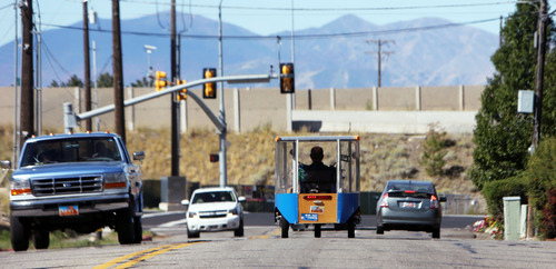 Francisco Kjolseth  |  The Salt Lake Tribune
Andy Schoenberg, a retired bioengineering professor from the University of Utah and a former NASA engineer, heads to the grocery store near Millcreek Canyon recently. Schoenberg, who has been developing solar-powered vehicles for about 15 years, is trying to bring them to market. His Ecotrikes harness the power of the sun through a solar panel that makes up the roof of the small vehicle that can be licensed as a motorcycle.