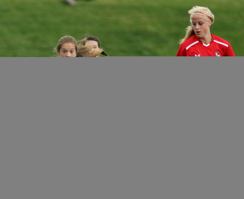 Steve Griffin  |  The Salt Lake Tribune

East's Janie Kearl, left, heads up field with the ball as Bountiful's Liz Crezee runs with her during match at East High School in Salt Lake City, Utah Tuesday, September 24, 2013.