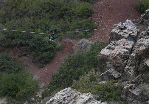 Scott Sommerdorf   |  The Salt Lake Tribune
One of two young men cactches himself after he lost his balance on a slack line at "Suicide Rock" near the mouth of Parley's Canyon, Thursday, September 26, 2013. He is wearing a safety harness. He successfully righted himself, and continued to the other side.