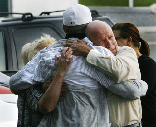Farmington -  Family and friends of Brian Wood console one another following press conference from Farmington Police chief Wayne Hansen,  outside police headquarters in Farmington, Sept. 23, 2008, where Hansen reveled that police did shoot and kill Wood after a day long stand-off in Farmington yesterday.  Steve Griffin/The Salt Lake Tribune 9/23/08