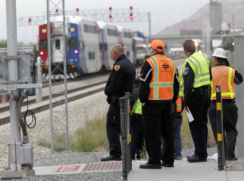 Al Hartmann  |  The Salt Lake Tribune
Salt Lake City Police and UTA investigate the scene at 500 West and 1700 South where a pedestrian was hit and seriously injured by a Front Runner train about 8:30 a.m. on Friday.