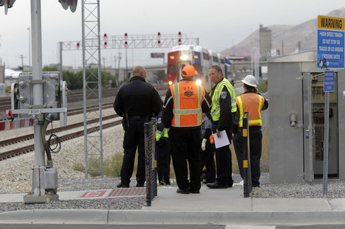 Al Hartmann  |  The Salt Lake Tribune
Salt Lake City Police and UTA investigate the scene at 500 West and 1700 South where a pedestrian was hit and seriously injured by a Front Runner train about 8:30 a.m. Friday, Sept. 27, 2013.