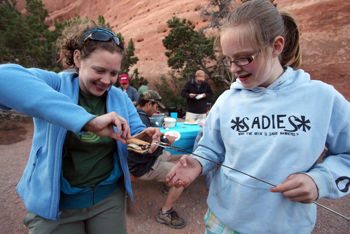Francisco Kjolseth  |  The Salt Lake Tribune
Being kids, Jenn Sartor, left, helps her niece Sydnee Sartor, 13, with a smore while camping in Arches in late May, 2013.