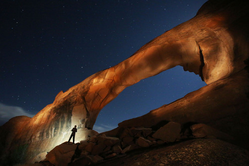 Francisco Kjolseth  |  The Salt Lake Tribune
Will Prettyman, 11, has fun playing the role of assistant as he lights up Skyline Arch next to the Arches National Park campground in late May.