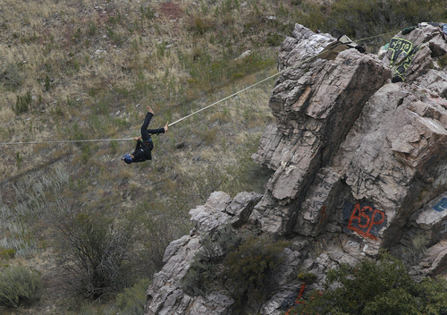 Scott Sommerdorf   |  The Salt Lake Tribune
Cameron Kolk loses his balance, but cacthes himself as he walked a high line at "Suicide Rock" near the mouth of Parley's Canyon, Thursday, September 26, 2013. He is wearing a safety harness.