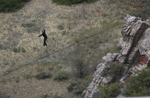 Scott Sommerdorf   |  The Salt Lake Tribune
Cameron Kolk walks a high line at "Suicide Rock" near the mouth of Parley's Canyon, Thursday, September 26, 2013.