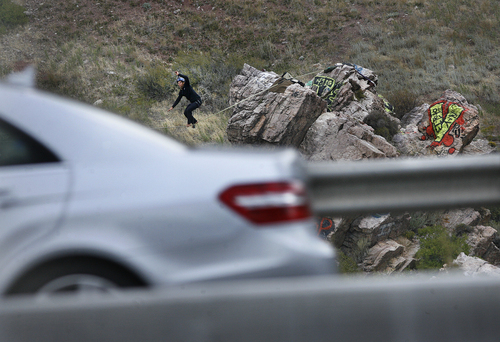 Scott Sommerdorf   |  The Salt Lake Tribune
Drivers on the I-215 beltway got an unexpected treat if they looked towards "Suicide Rock" where Cameron Kolk walked a high line near the mouth of Parley's Canyon, Thursday, September 26, 2013.