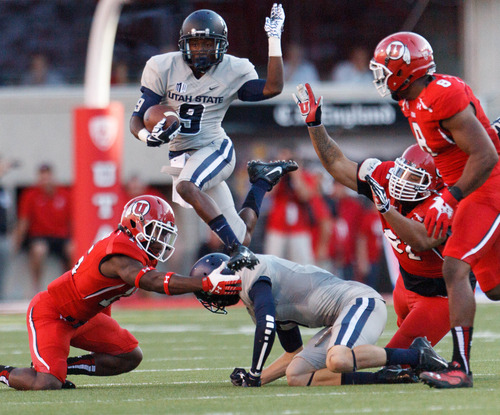 Trent Nelson  |  The Salt Lake Tribune
Utah State Aggies wide receiver Bruce Natson (9) leaps into the air as the University of Utah hosts Utah State, college football Thursday, August 29, 2013 at Rice-Eccles Stadium in Salt Lake City.