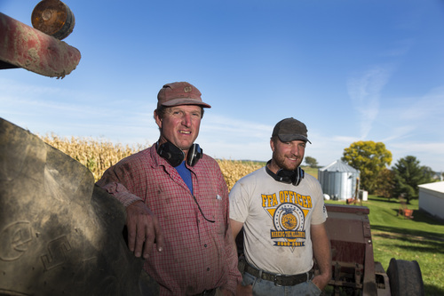 Tom Duerst, left, and his son Tyler Duerst, pose on their farm near Verona, Wis., Friday Sept. 27, 2013. The two famers both wear ear protection when working on the farm.  An estimated one-third of the nation's three million farmers have some level of hearing loss caused by their inner ears' daily bombardment from sounds that can rival a rock concert's sonic impact. Even farmers still in their 20s can end up with the muffled hearing of someone in middle age if they fail to protect their hearing. (AP Photo/Andy Manis)
