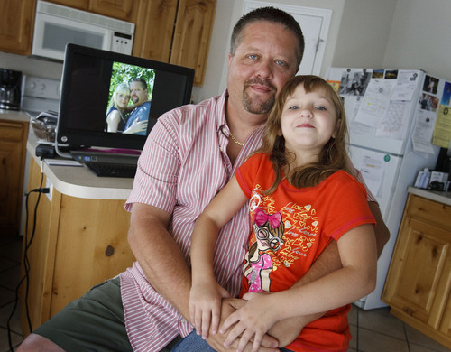 Leah Hogsten | The Salt Lake Tribune
Nathan Adams of Syracuse, Utah, and his daughter Vanessa, 6, Skype with Elena Adamchiyk in Odessa, Ukraine on the computer behind them, Saturday, August 24, 2013. Adams met  Adamchiyk online in the summer of 2012 and has been there twice to visit her.  Elena had just received a visa to come to the U.S; she has since arrived in Utah and the two plan to marry.