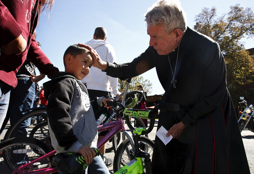 Leah Hogsten | The Salt Lake Tribune
Marius Vigil, 5, receives a blessing from affiliated clergyman LeRoy Carter, Saturday, September 28, 2013 during the ì8th Annual Blessing of the Bikesî at the Cathedral Church of St. Mark. The event was aimed at raising awareness of bicycle safety for anyone on on or two wheels including scooters, bicycles, motorcycles, unicycles, tricycles,