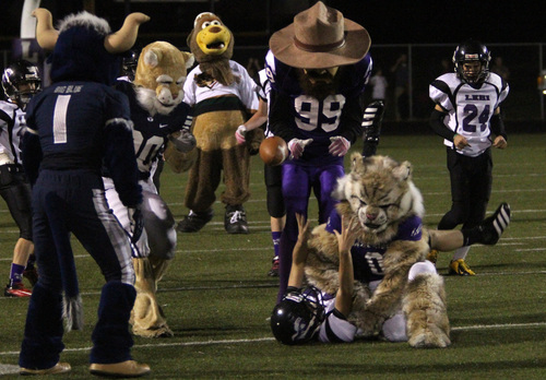 Rick Egan  | The Salt Lake Tribune 

Willy the wildcat makes a tackle, during the Mascot bowl at Lehi High, Monday, September 30, 2013.