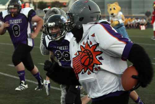 Rick Egan  | The Salt Lake Tribune 

The Sun's Gorilla runs with the ball for the mascot's, during the Mascot bowl at Lehi High, Monday, September 30, 2013.