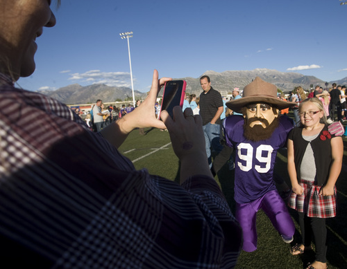 Rick Egan  | The Salt Lake Tribune 

Brymnlee Darger, 9, has her photo taken Pioneer Pete, with before the Mascot bowl at Lehi High, Monday, September 30, 2013.