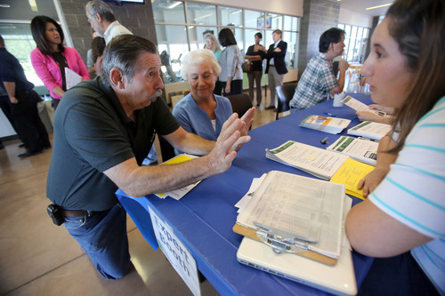 Francisco Kjolseth  |  The Salt Lake Tribune
Lynn Spencer, left, of Murray expresses his frustration with getting signed up with the new Affordable Care Act alongside his wife Shannon as they speak with Medicaid outreach worker Rebecca Vazquez(cq) on Tuesday, Oct. 1, 2013. Shannon, who is in the high-risk pool, loses coverage on Dec. 31 and they are anxious to get her signed to avoid a lapse in coverage. The Spencers were at the Sorenson Unity Center in Salt Lake where people could enroll in the new insurance after a press conference.