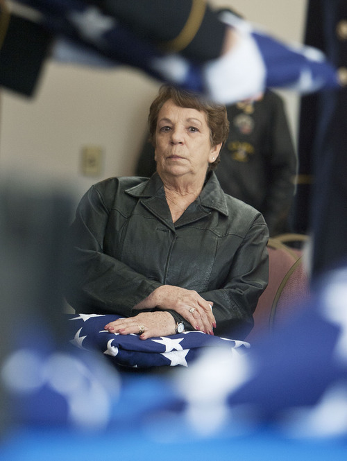 Steve Griffin  |  The Salt Lake Tribune

Maryann Edgeman, of Tooele, holds a flag given to her during the Utah volunteers of the Missing In America Project's Military Funeral Service for 11 unclaimed Utah veterans (and one spouse) whose remains have been in the care of two area mortuaries at the Utah Veterans Cemetery and Memorial Park in Bluffdale, Utah Thursday, October 3, 2013. Edgeman's brother, Ralph George Hartley, a U.S. Army Vietnam veteran, was one of the veterans honored.