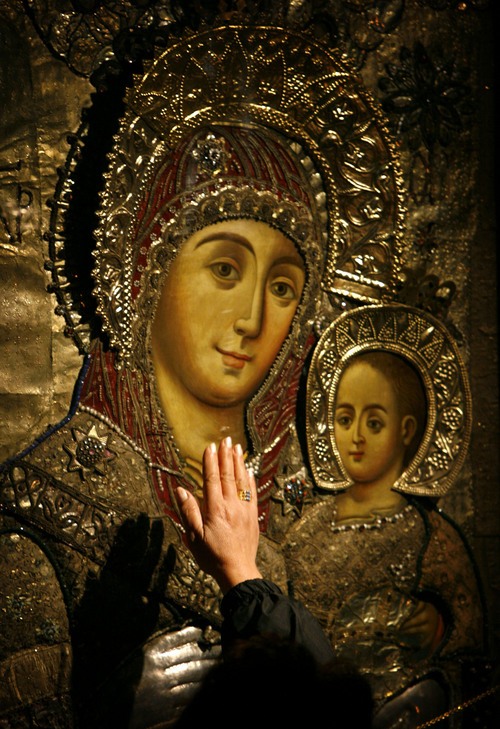 A Christian pilgrim touches an icon of the Virgin Mary inside the Church of the Nativity, traditionally believed by many to be the birthplace of Jesus Christ, in the biblical West Bank town of Bethlehem, Saturday, Dec. 22, 2007.  The number of foreign visitors this Christmas is expected to swell to levels seen before fighting with the Palestinians broke out seven years ago, Israeli tourism officials said.  Palestinian officials are anticipating more pilgrims to visit the biblical West Bank town than in recent years. (AP Photo/Alvaro Barrientos)