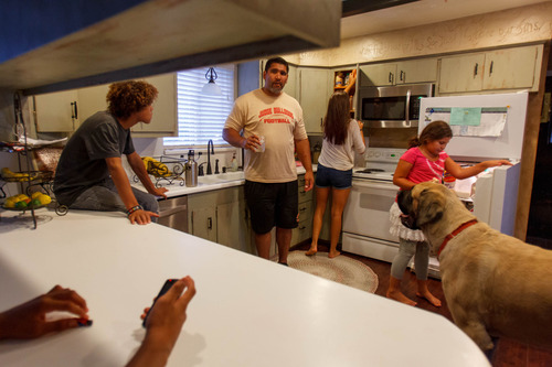 Trent Nelson  |  The Salt Lake Tribune
Former NFL star Luther Elliss in the family's kitchen with some of his twelve children, Wednesday, August 28, 2013, in Millcreek. Left to right, Isaiah, Luther, Olivia, Sophia and the family dog Koa.