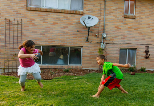 Trent Nelson  |  The Salt Lake Tribune
Sophia Ellis playing football with her brother Elijah Wednesday, August 28, 2013, in Millcreek.