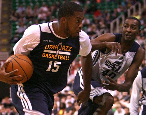Leah Hogsten | The Salt Lake Tribune
l-r Utah Jazz forward Derrick Favors passes Jeremy Evans during the scrimmage. Utah Jazz fans filled  EnergySolutions Arena to get a glimpse at this year's players during the annual scrimmage Saturday, October 5, 2013. The Jazz roster currently includes 20 players, but NBA rules require that that number must be reduced to 15 by opening night, Oct. 30 against Oklahoma City.