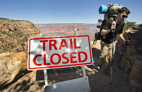 Grand Canyon Park Closed-10-1-2013- Sebastian Ramirez, 27, of Austin, Texas, hikes out of the Bright Angel Trail in Grand Canyon National Park, Tuesday afternoon.  Ramirez spent the night with friends in the bottom of the Canyon at Bright Angel Campground. Beginning at 6 am, visitors were told the park was closed and they could not visit.    (AP Photo/The Arizona Republic, Tom Tingle)  MARICOPA COUNTY OUT; MAGS OUT; NO SALES   MBO