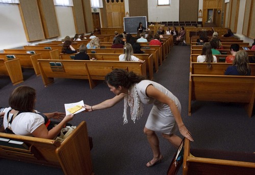 Leah Hogsten | The Salt Lake Tribune
Rebekah Ellsworth passes papers to another member of the Relief Society of the Parley's Seventh Ward during their meeting Sunday, Sept. 22, 2013. The ward is for LDS singles only, ages 31-45, and has some 429 women and 264 men.