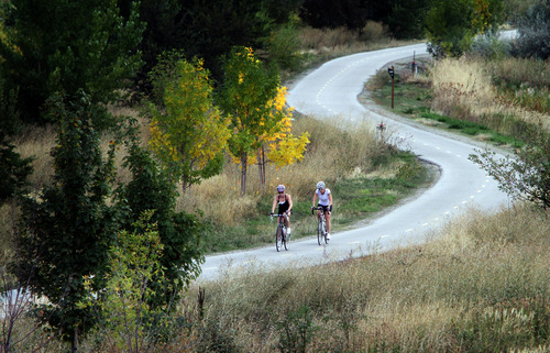 Rick Egan  | The Salt Lake Tribune 

Two cyclists enjoy the warm temperatures, as they ride the Legacy Parkway Trail in Farmington, Monday, October 7, 2013.