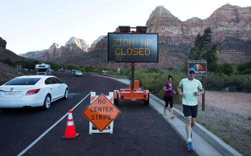 Steve Griffin  |  The Salt Lake Tribune
A sign tells visitors to Zion National Park that the park is closed due to the federal government shutdown Tuesday October 1, 2013. Gov. Gary Herbert is asking President Obama to let the state operate Utah's national parks during the shutdown, saying their closure is hurting the economy.