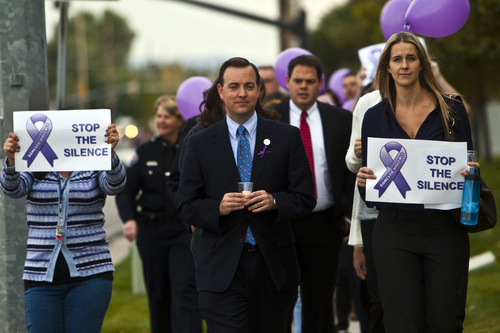 Chris Detrick  |  The Salt Lake Tribune
Mayor Mike Winder and West Valley City Attorney's Office Victim Services Coordinator Rachelle Hill participate during a march to support domestic violence victims at West Valley City Hall Tuesday October 8, 2013. The city is displaying more than 40 metal silhouettes in city hall to represent each person killed in a domestic violence homicide in the history of West Valley City.