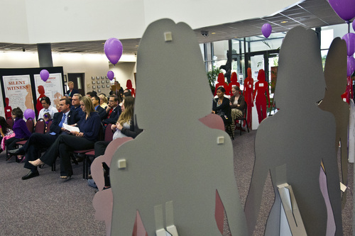Chris Detrick  |  The Salt Lake Tribune
People listen as West Valley City Attorney Ryan Robinson speaks after a march to support domestic violence victims at West Valley City Hall Tuesday October 8, 2013. The city is displaying more than 40 metal silhouettes in city hall to represent each person killed in a domestic violence homicide in the history of West Valley City.